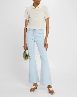 Person wearing a light-colored polo shirt and light blue jeans on a white background